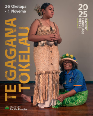 A person is standing in traditional dress looking to the right of the camera. Another person is sitting on the ground smiling as she fixes the bottom of the other person's dress.  Text says 26 Oketopa - 1 Novema. Te Gagana Tokelau. The image features small 2025 Pacific Language Weeks and Ministry for Pacific Peoples logos.