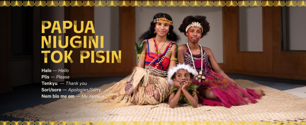 A screensaver graphic for Papua New Guinea Pidgin Language Week, featuring a photo of three Papua New Guinea girls in traditional attire sitting on a woven mat 